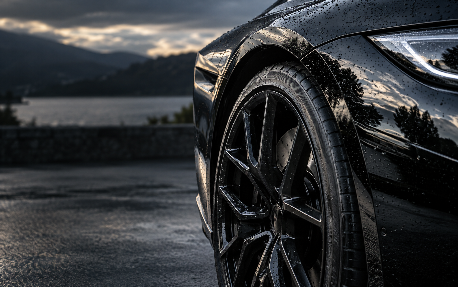 Illustrative close-up of water beads on a freshly detailed black car